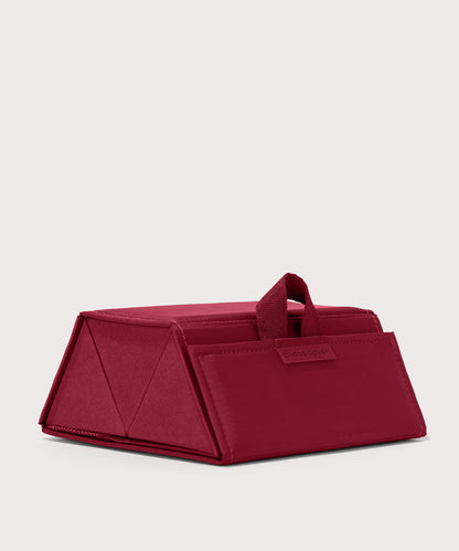 Dagne Dover Remi foldable glasses holder in spice red seen from an angle.