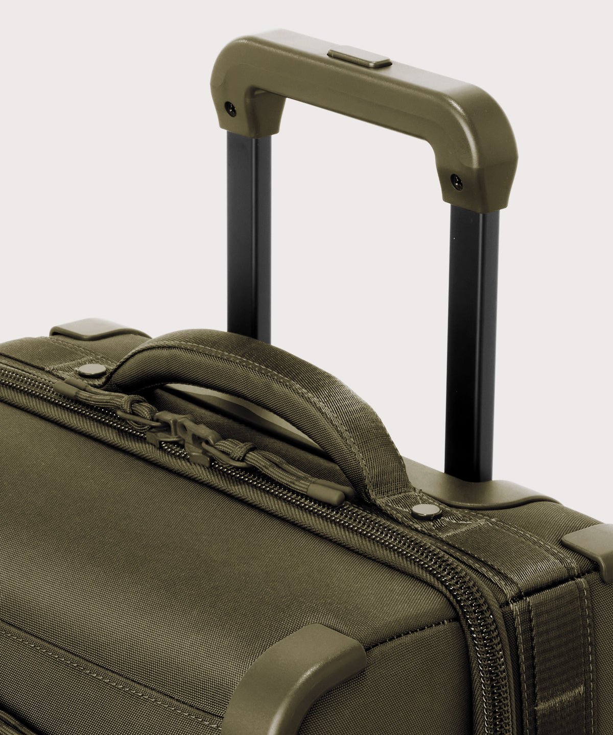 Detail shot of Seattle carry-on rolling luggage 20.5” in dark green extended luggage handle and puffy handle