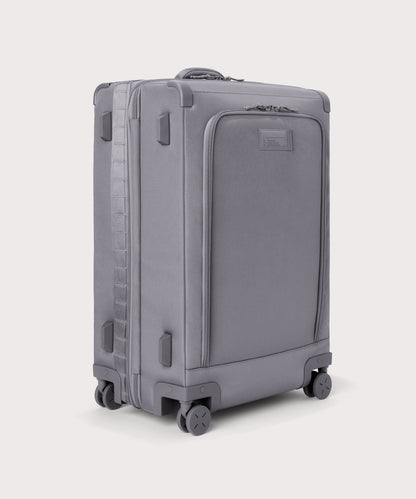 3/4 front view of Sydney checked rolling luggage 28.5” in light grey showing side luggage feet